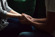 Close up woman and man in love sitting on couch, two people holding hands. Symbol sign of sincere feelings, compassion, loved one, say sorry. Reliable person, trusted friend, true friendship concept
