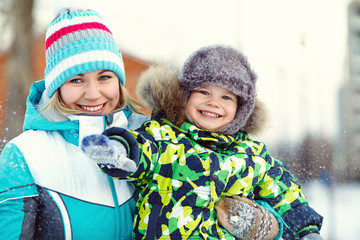 happy mother and son in winter park