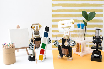 metal robot with a brush in his hand. stem plus art is equal to steam. science, technology, engineer