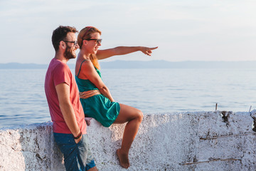 Wall Mural - Young couple in love enjoying their honeymoon at the seaside