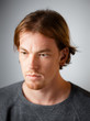 © stas_malyarevsky - Male portrait of a fair-haired man of European appearance, on a white background. Emotions. Serious face