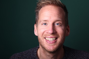 Portrait of a man in front of a colored background