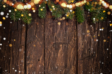 Christmas spruce branches on wooden background.