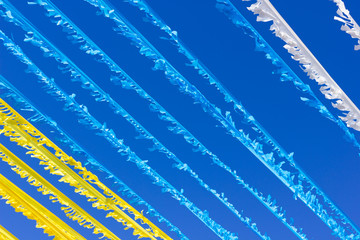 Canary Islands flag color stripes blowing in the wind over blue sky. Traditional party, local celebration decoration in Gran Canaria, Spain