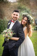 young couple bride groom getting married wedding posed photos at seaside sea beach hairpiece flowers bouquet church