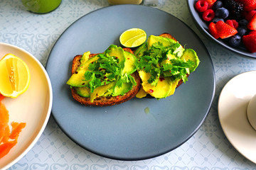 Wall Mural - Healthy breakfast with avocado toast and fresh berries