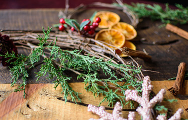 Rustic Holiday Wreath with grape vine, evergreen, sliced dried oranges and traditional cranberry organic healthy holiday natural background