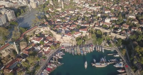 Wall Mural - High altitude aerial drone video reverse rising zoom out to reveal Kaleici old town ships in waterfront harbor and Mediterranean Sea in Antalya, Turkey. 4k at 23.97fps