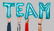 © Rawpixel.com - Hands showing team balloons word