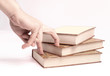 © yurolaitsalbert - closeup.the person is choosing one book from the stack. photo with copy space