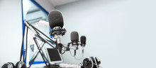 Technology And Audio Equipment Concept - Microphones At Recording Studio Or Radio Station
