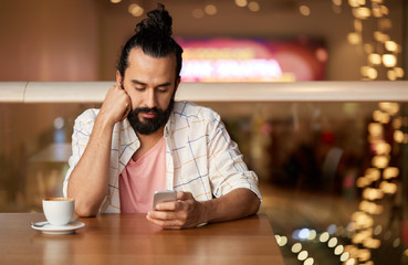 Sticker - people, technology and leisure concept - man drinking coffee and messaging on smartphone at restaurant or cafe