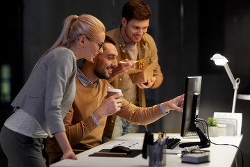 Wall Mural - business, deadline and technology concept - coworkers with computer and takeout food and coffee work