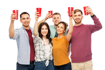 Wall Mural - celebration, friendship and people concept - group of smiling friends with non alcoholic drinks in party cups over white background