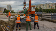 Installing Concrete Plates By Crane At Road Construction Site Timelapse.
