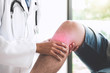 Doctor checking patient with knees to determine the cause of illness