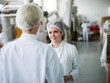 © Dusan Petkovic - Two female workers discussing about food quality while standing in food factory.