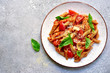 canvas print picture - Penne pasta with tomato in red sauce.Top view with copy space.