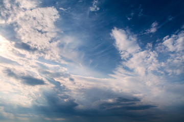 Wall Mural - white curly clouds in a blue sky. sky background