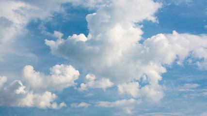 Wall Mural - white curly clouds in a blue sky. sky background