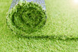 © Dmytro - Artificial turf roll. Synthetic grass lawn laying background.