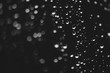 © Daniil - Dirty window glass with drops of rain. Atmospheric monochrome dark background with raindrops in bokeh. Droplets and stains close up. Detailed transparent texture in macro. Copy space. Rainy weather.