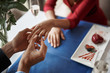 © Yakobchuk Olena - Concept of romantic engagement. Top angle portrait of young gentleman putting ring on finger of his lover as marriage proposal