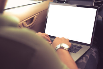 Business man or Freelancer sitting in the front seat of a car working behind a laptop close-up,warm retro tone.