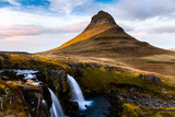 Fototapeta Góry - Iconic Kirkjufell Mountain and Waterfall in Iceland on an Autum Late Afternoon.