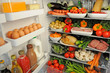 VIEW INSIDE REFRIGERATOR WITH SHELVES FILLED WITH FRESH FOOD