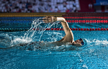 Man in swimming pool. Crawl swimming style