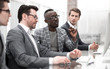 © ASDF - businessman and his business team sitting in the computer room