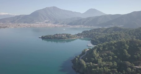 Wall Mural - Backwards aerial drone video descending view of cityscape, natural harbor and mountains around Fethiye, Turkey. 4k at 23.97fps