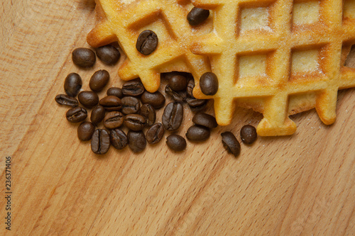 Fotografía Tasty fresh Belgian wafers, grain coffee on a wooden background, copy space