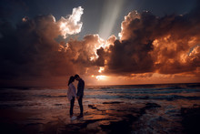 Couple In Love At A Fiery Sunset.Silhouette Photo