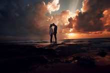 Couple In Love At A Fiery Sunset.Silhouette Photo