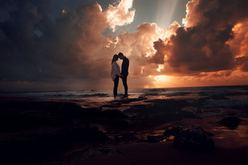 Couple in love at a fiery sunset.Silhouette photo