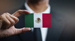 © natanaelginting - Businessman Holding Card of Mexico Flag