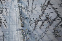 Electrical substation in the snow in winter. High voltage wires.