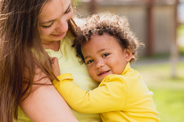 happy caucasian white mother holding 18-month baby