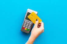 Pay By Payment Terminal. Paypass  Technology. Woman's Hand Hold Credit Card, Bring Card To Terminal  On Blue Background Top View Copy Space