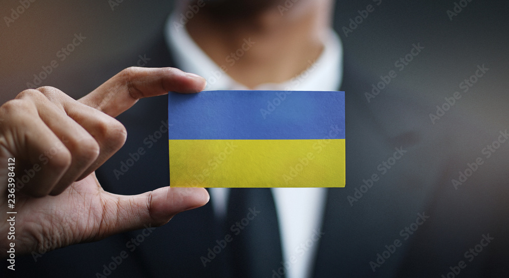 Businessman Holding Card of Ukraine Flag - obrazy, fototapety, plakaty 