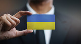 Fototapeta  - Businessman Holding Card of Ukraine Flag