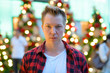 © Ranta Images - Face Of Young Handsome Hipster Man Against Christmas Trees Outdoors