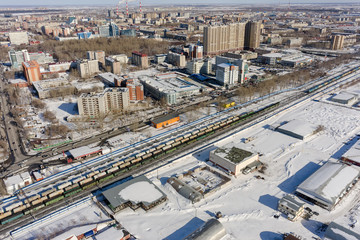 Wall Mural - Tyumen, Russia - March 11, 2016: The railroad along 50 let VLKSM Street, dividing residential and industrial districts of city