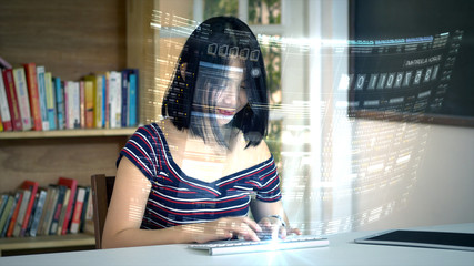 Young Asian teenage girl typing on a futuristic concept wireless keyboard using a holographic head up display computer terminal to surf the net and search for online informations and communication