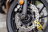 Fototapeta Tęcza - theft protection is mounted on the motorcycle brake disc