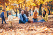 © Mediteraneo - Multl generation family in autumn park having fun