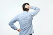 © Viktor Koldunov - Studio shoot of young man in blue shirt standing back to the camera. He is trying to select something and make a right decision.