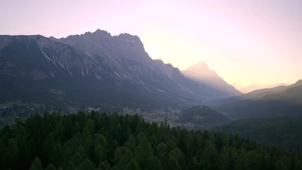 Wall Mural - Scenic sunrise over Italian Dolomites near Cortina d'Ampezzo. Early morning shot of autumn mountains with colorful trees in first rays of sunlight.